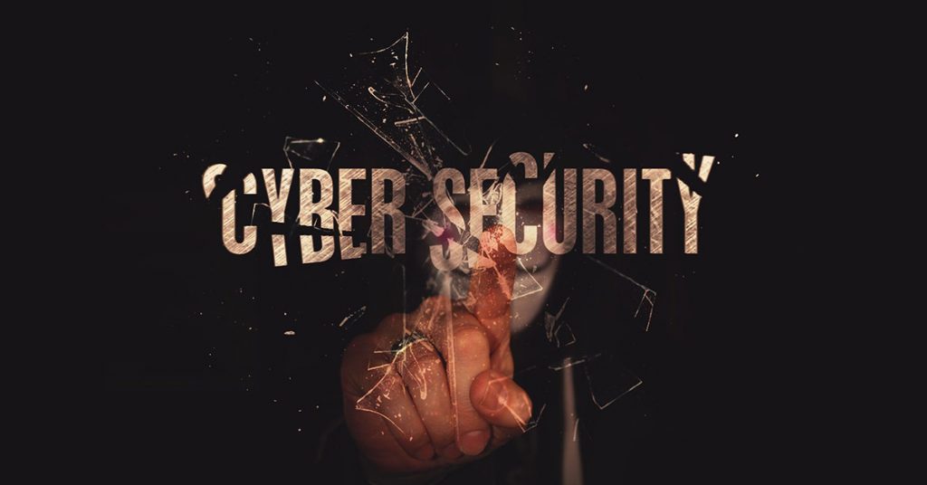 A digital cyber security wallpaper showing a masked individual as a cybercriminal