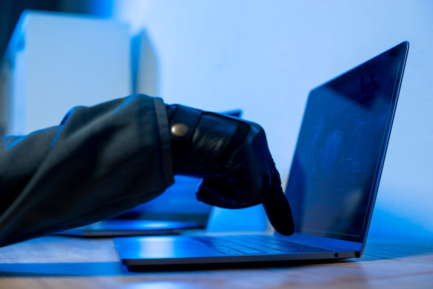 Close-up of a hacker tapping on a keypad