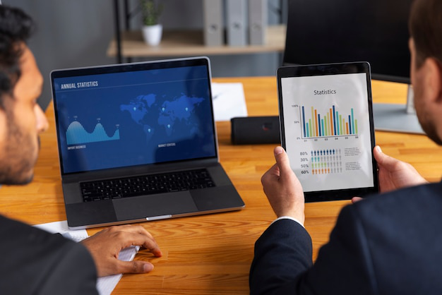 Business professional analyzing financial graphs and charts on a computer screen.