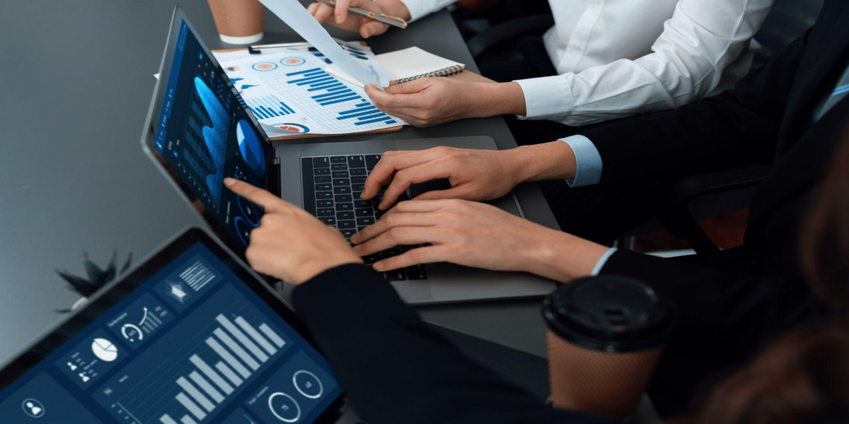 Finance professionals reviewing automated financial dashboards on a laptop and tablet, illustrating Sage Intacct and Sage 300 automation features in action