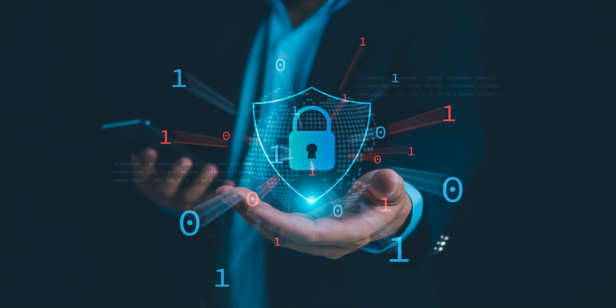Businessman holding digital shield representing protection against cyber attacks.