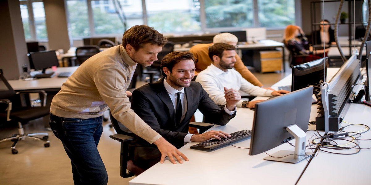 Young business professionals managing e-commerce operations and IT systems in an office.