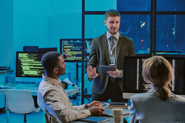 Cyber Security expert sharing insights with colleagues in an office meeting