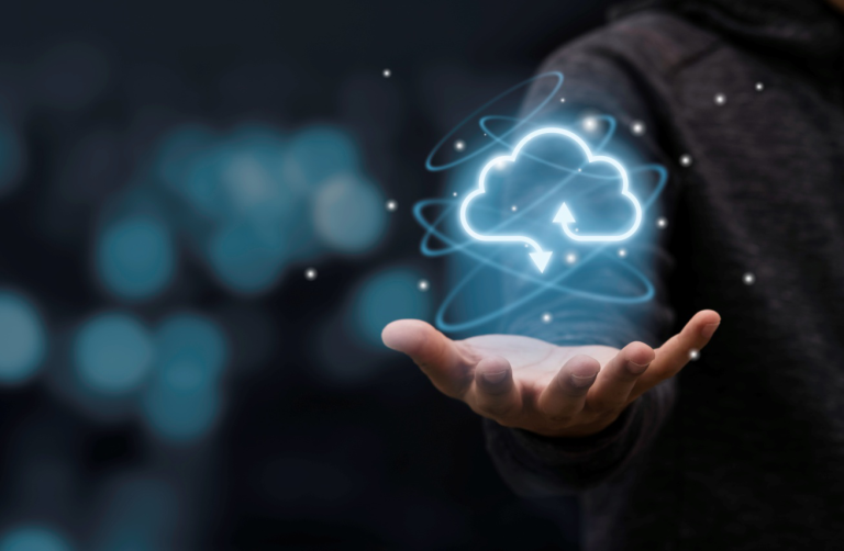 Businessman holding a virtual cloud icon representing data transfer and digital transformation.