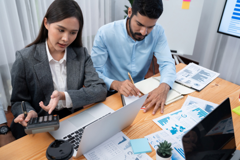 Diverse business team reviewing financial dashboards and data analytics reports.