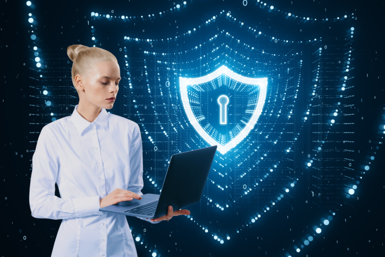 Employee using laptop with digital security shield representing human firewall cybersecurity training
