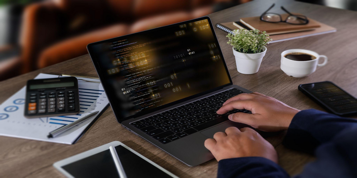 A professional working on a laptop.