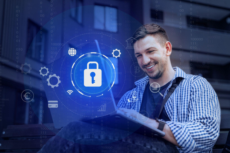 Young man using digital security tools on a device in an outdoor urban setting.