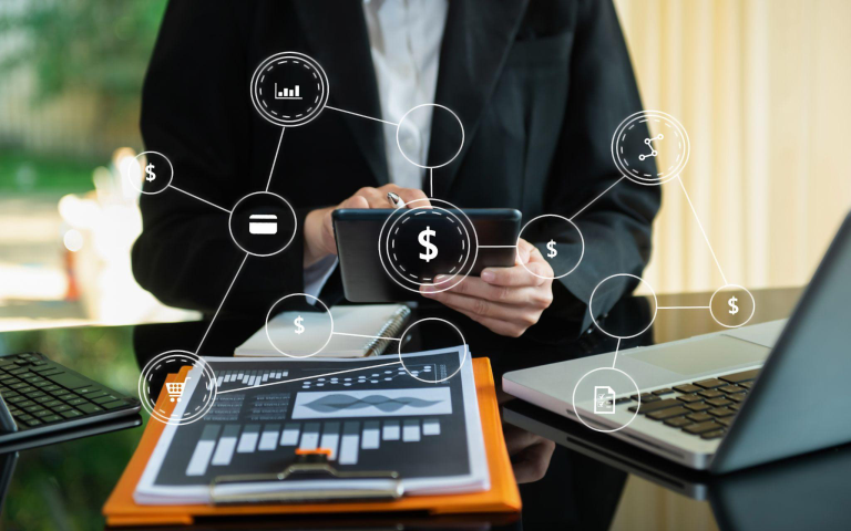 Person using a smartphone and tablet with digital business icons overlaid.