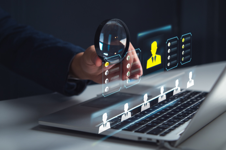 HR professional reviewing employee onboarding and records management through a digital HRMS system on a laptop.