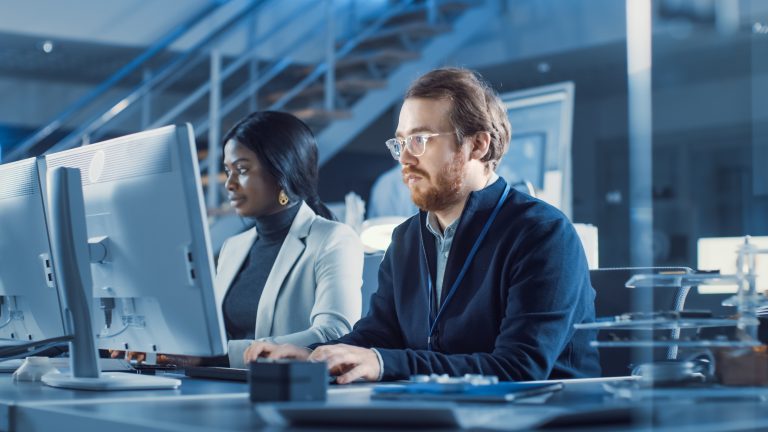 IT professionals managing network and system performance in a modern office environment.