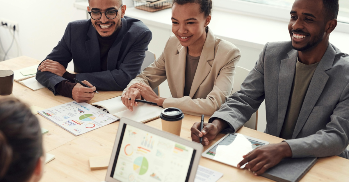 four people discussing something during a meeting