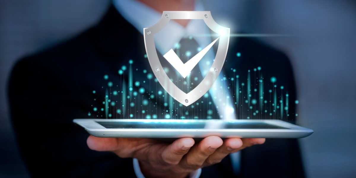 Managed-IT-Services-Markham A person holding a tablet with a holographic security icon above it