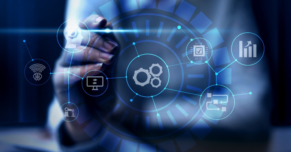 A person’s hand holds a stylus and touches a screen with digital mapping with various symbols with cogs, machines, and charts, showcasing the importance of having Managed IT Services for businesses to work through the complexities.