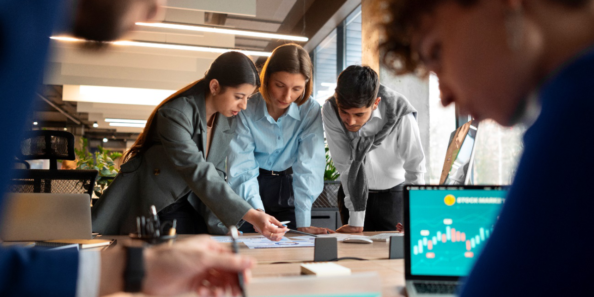 A team of professionals collaborating over documents and analyzing data