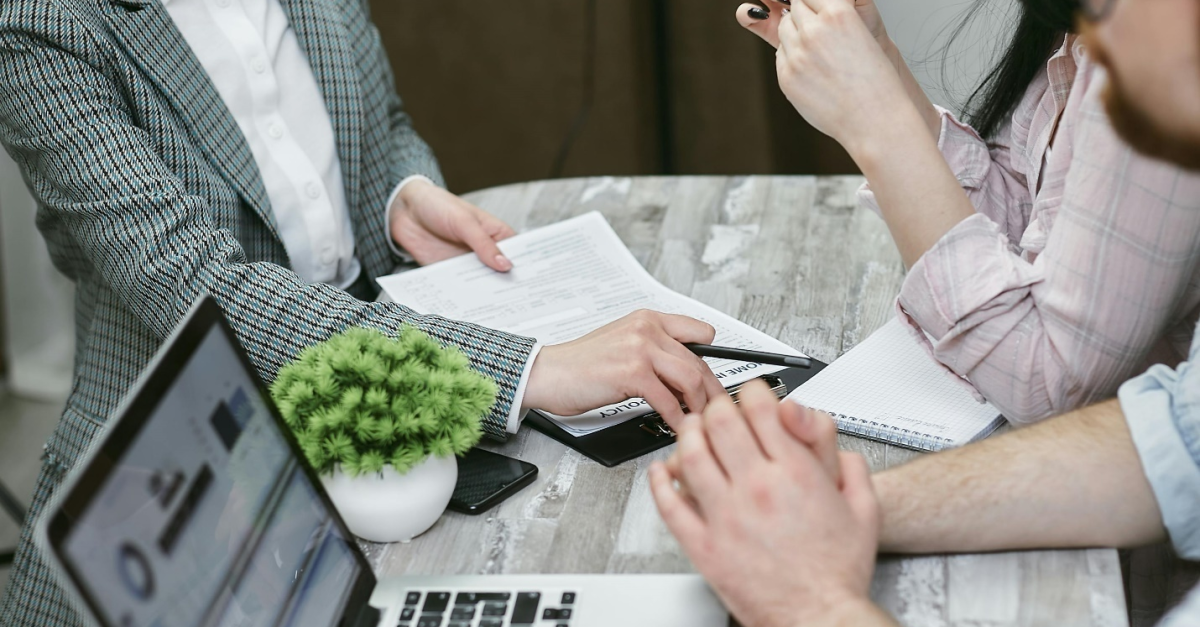 open-laptop-desk-three-people-Sage-Consultants