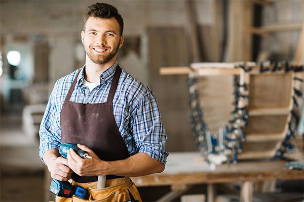 smiling-craftsman-with-electric-drill